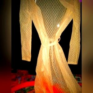 Cream colored long sleeve see through garment